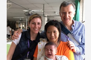 Dr. Fusi and Craig Posing With Thai Mom and Crying Baby